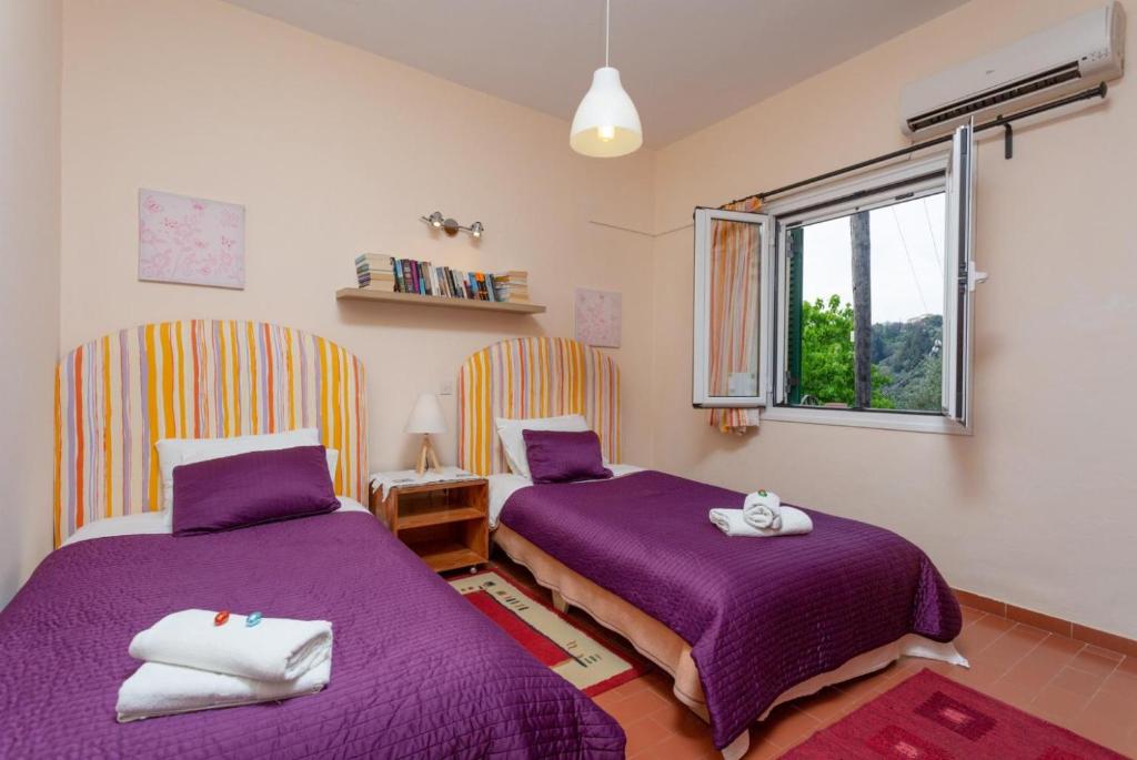 Postel nebo postele na pokoji v ubytování Bougainvillea