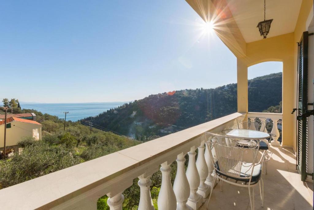 a balcony with a view of the ocean at Bakers House Upper in Corfu