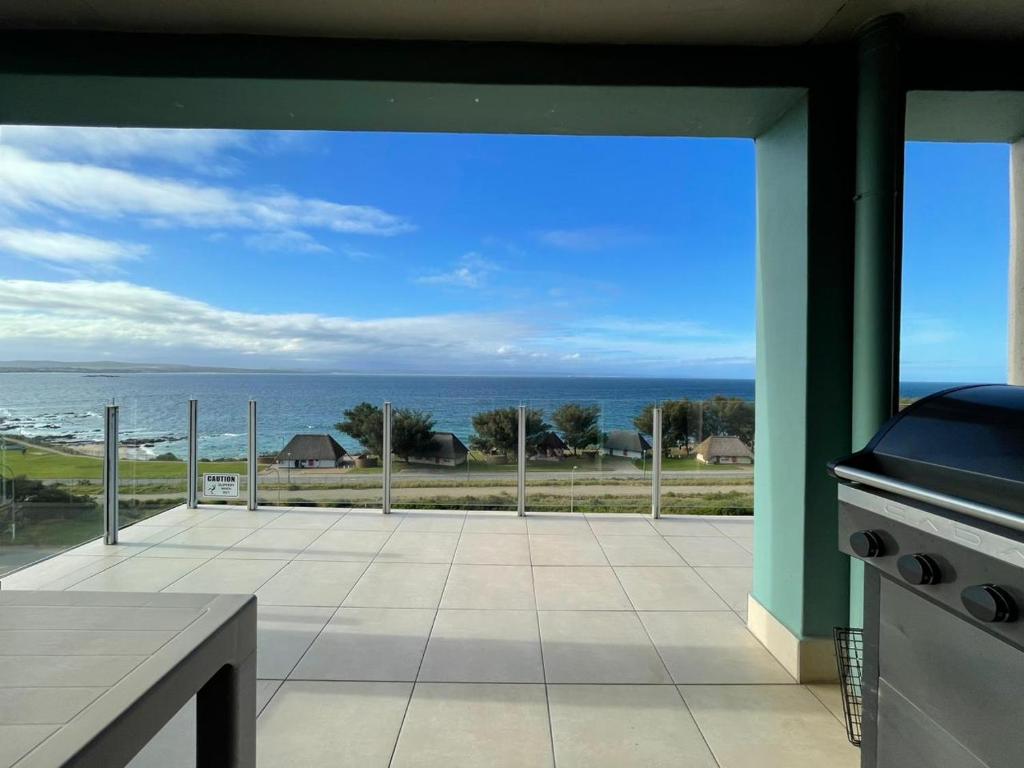 a large patio with a view of the ocean at Nautica Flat 301 in Mossel Bay