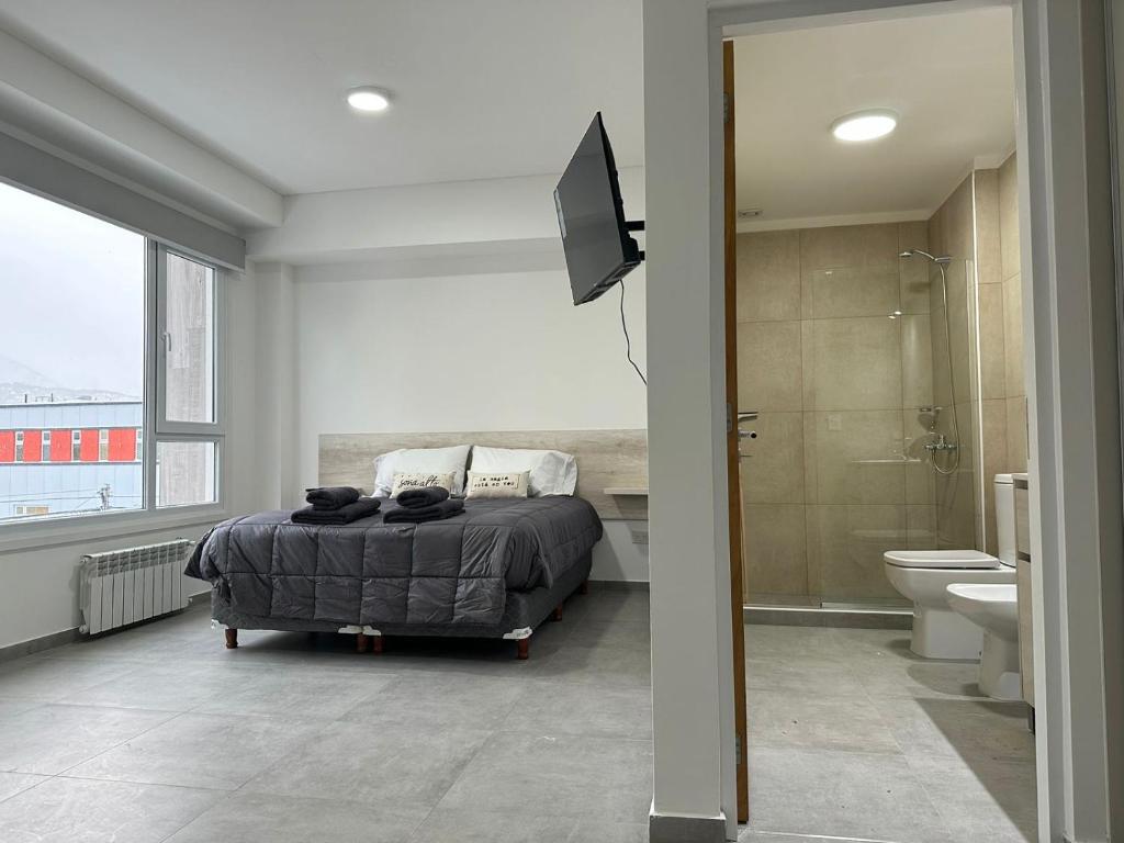 sypialnia z łóżkiem oraz łazienka z prysznicem w obiekcie Jainen Apartamentos w mieście Ushuaia