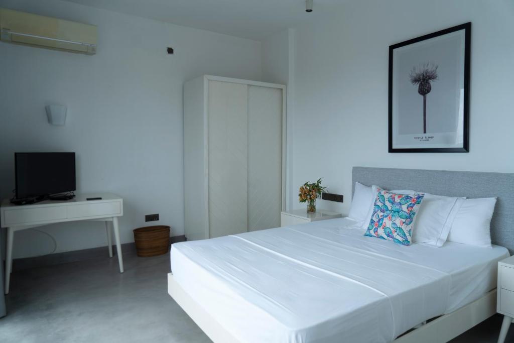 Postel nebo postele na pokoji v ubytování Four Petals Inn