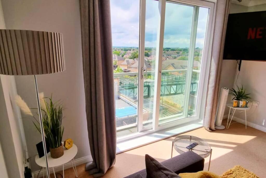 a living room with a large window with a view at BookApartments.CoHeathrow - Top Apartment Skyline views in London