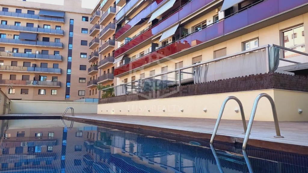 a swimming pool in front of a building at Barcelona Beach Breeze in Barcelona