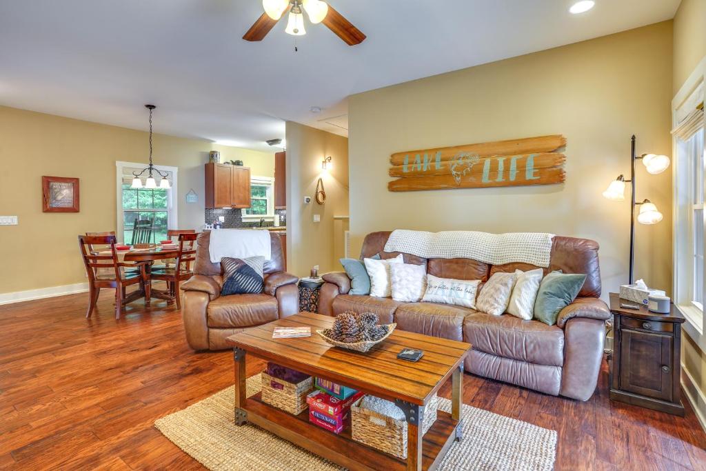 a living room with a couch and a table at Rustic Retreat in Cadiz On Lake Barkley in Cadiz