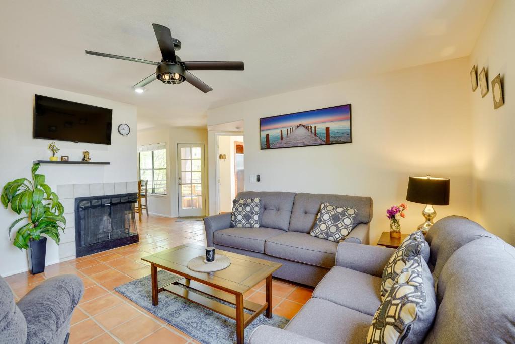 a living room with a couch and a fireplace at Tucson Oasis Heated Pool, Tennis Court, Hiking! in Tucson