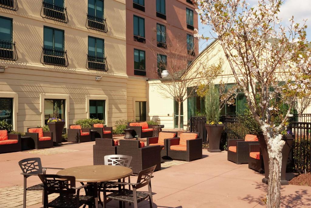 a patio with tables and chairs in a courtyard at Hilton Garden Inn Atlanta Airport/Millenium Center in Atlanta