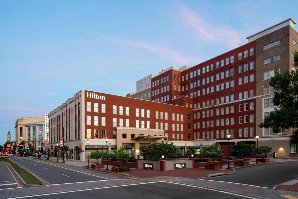 a large brick building on a city street at Hilton Richmond Downtown in Richmond