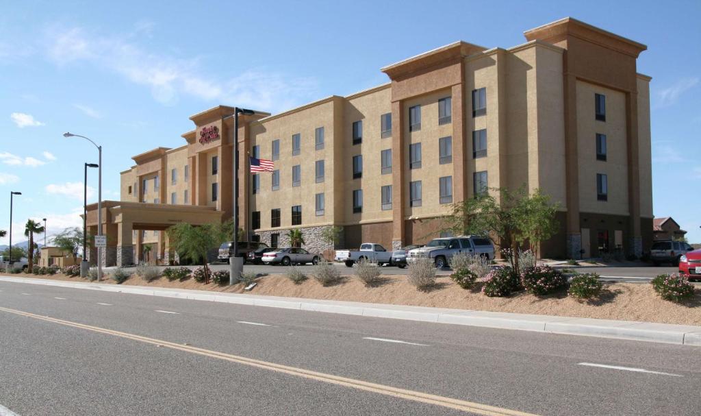 a building with an american flag in front of a street at Hampton Inn and Suites Barstow in Barstow