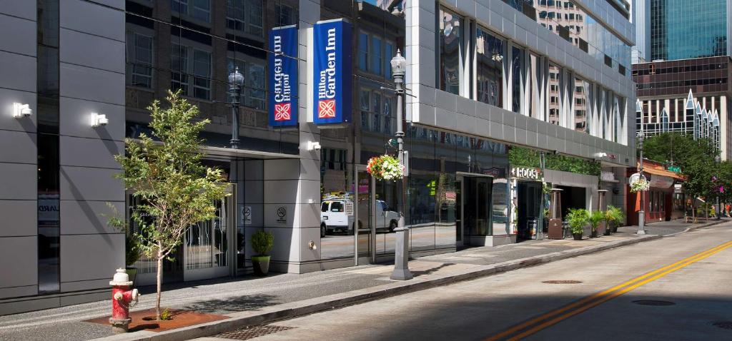 a city street with a fire hydrant in front of a building at Hilton Garden Inn Pittsburgh Downtown in Pittsburgh