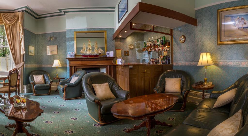 a living room with chairs and a barber shop at Balincourt in Bournemouth