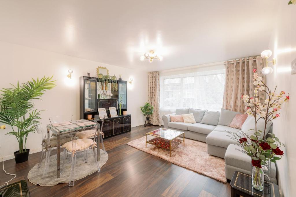 a living room with a couch and a table at Home near Excel, Stratford and Canary Wharf in London