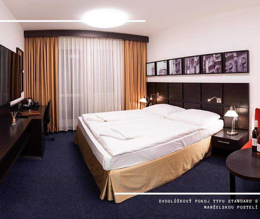Postel nebo postele na pokoji v ubytování Hotel Kamzík ***