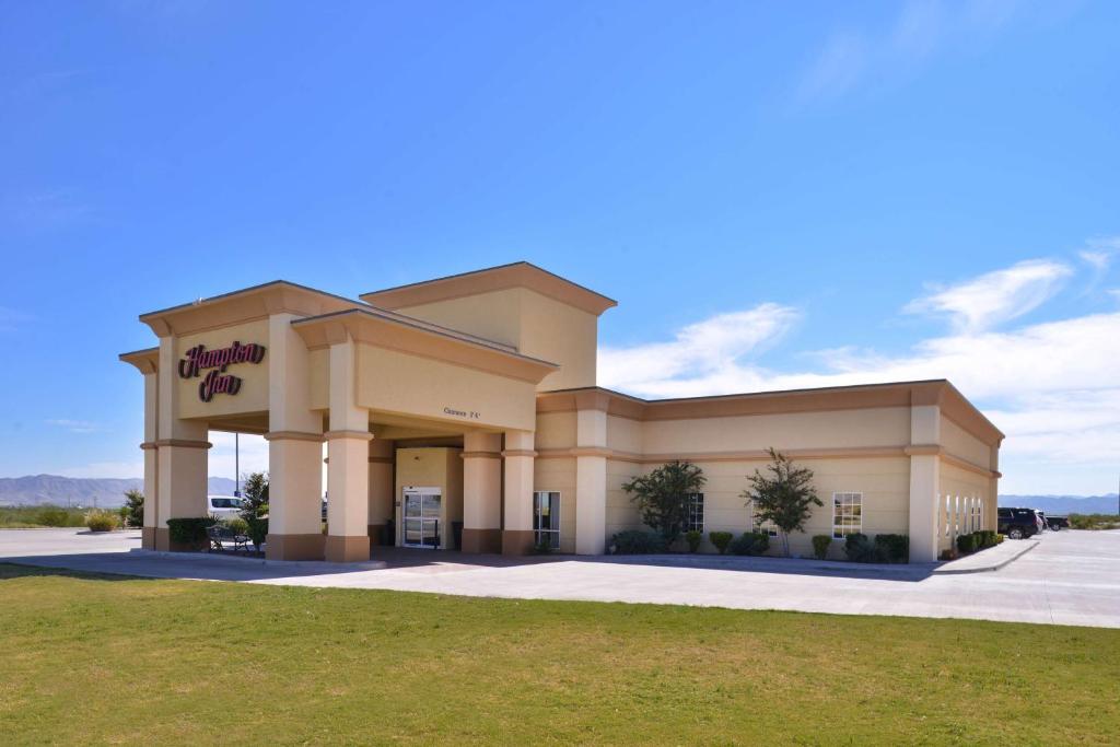 a large building with a sign in front of it at Hampton Inn Van Horn in Van Horn