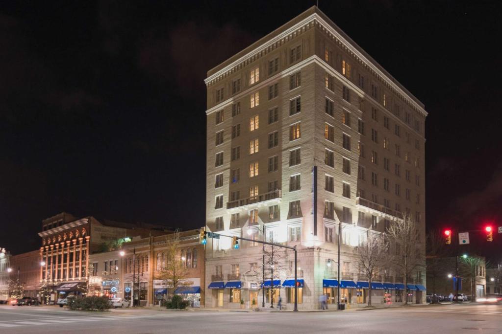 a large building on a city street at night at Hampton Inn & Suites Montgomery-Downtown in Montgomery