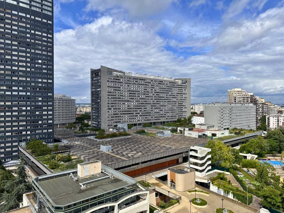 a large building in a city with tall buildings at Magnifique Appart. spacieux 8P/ Défense-Courbevoie in Courbevoie