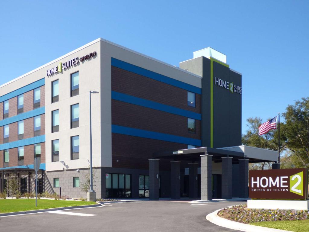 an office building with a sign in front of it at Home2 Suites By Hilton Pensacola I-10 Pine Forest Road in Pensacola