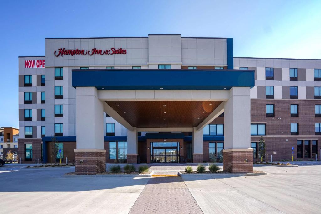 a building with a sign on the front of it at Hampton Inn & Suites Aurora South, Co in Aurora