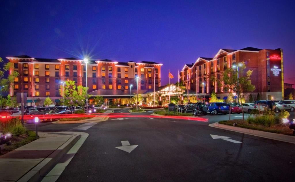 an empty parking lot in a city at night at Hilton Garden Inn Rockville - Gaithersburg in Rockville