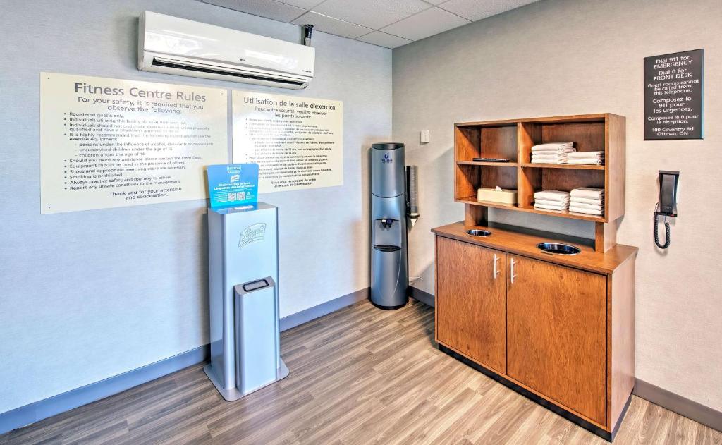 a room with a refridgerator next to a shelf at Hampton by Hilton Ottawa in Ottawa