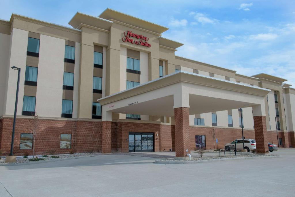 a hotel with a sign on the front of it at Hampton Inn & Suites Bay City in Bay City