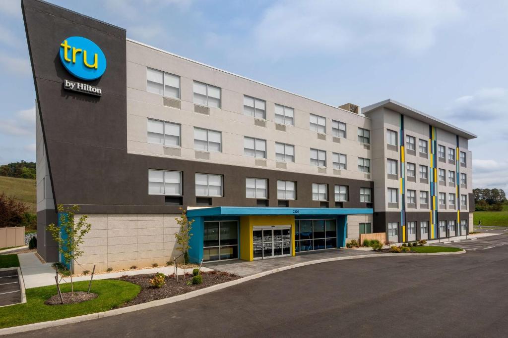 an exterior view of a hotel with a building at Tru By Hilton Radford in Christiansburg