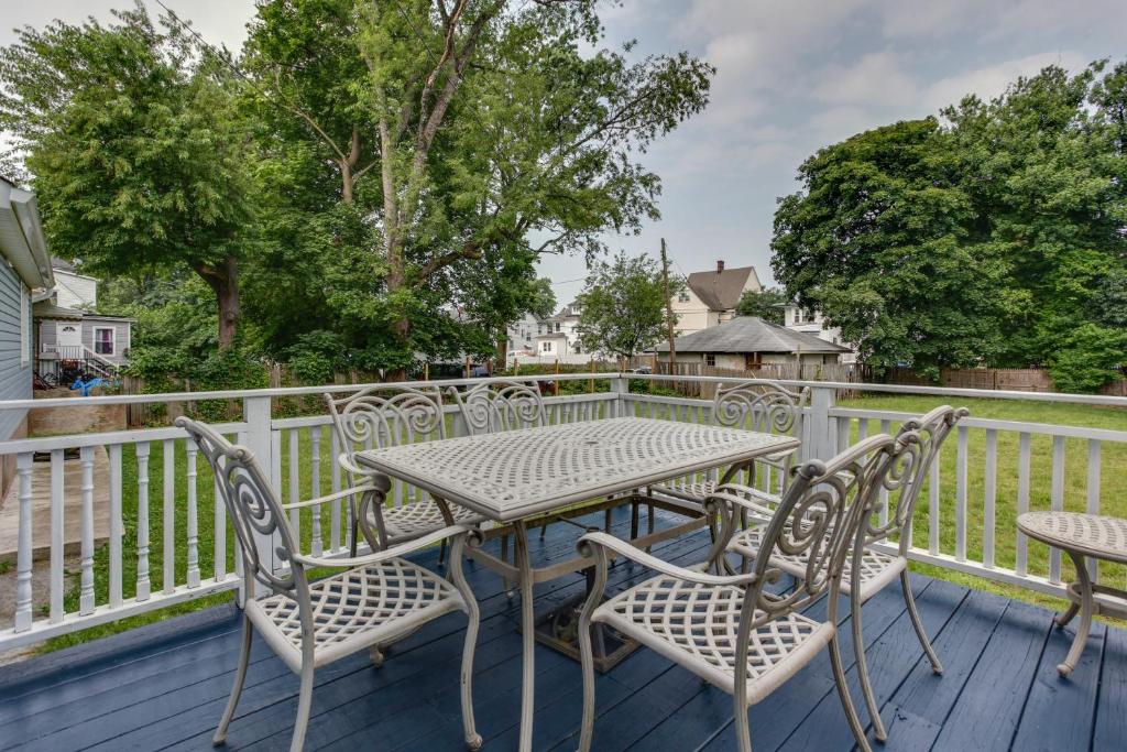 a patio with a table and chairs on a deck at Updated Apartment Near New York City! in East Orange