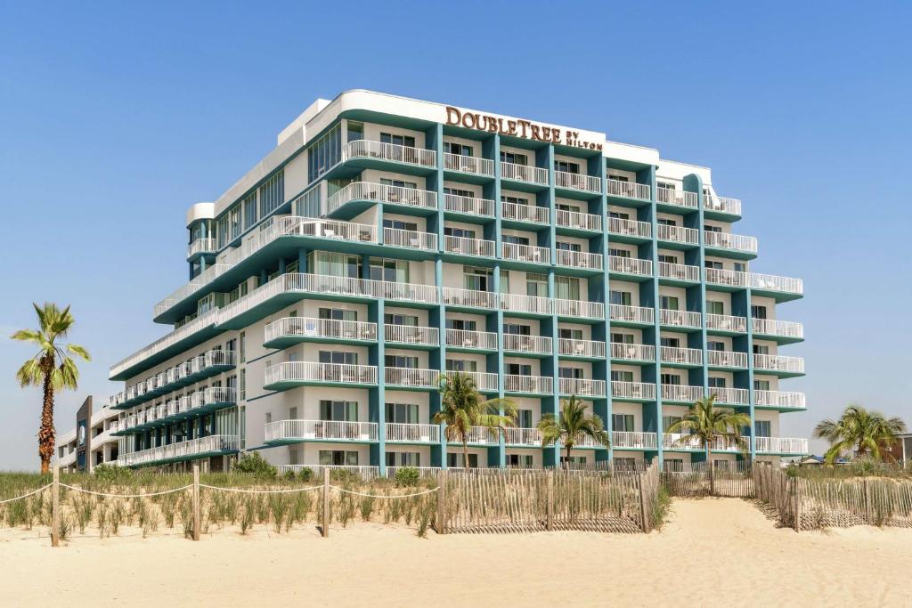 a hotel on the beach next to the beach at DoubleTree by Hilton Ocean City Oceanfront in Ocean City