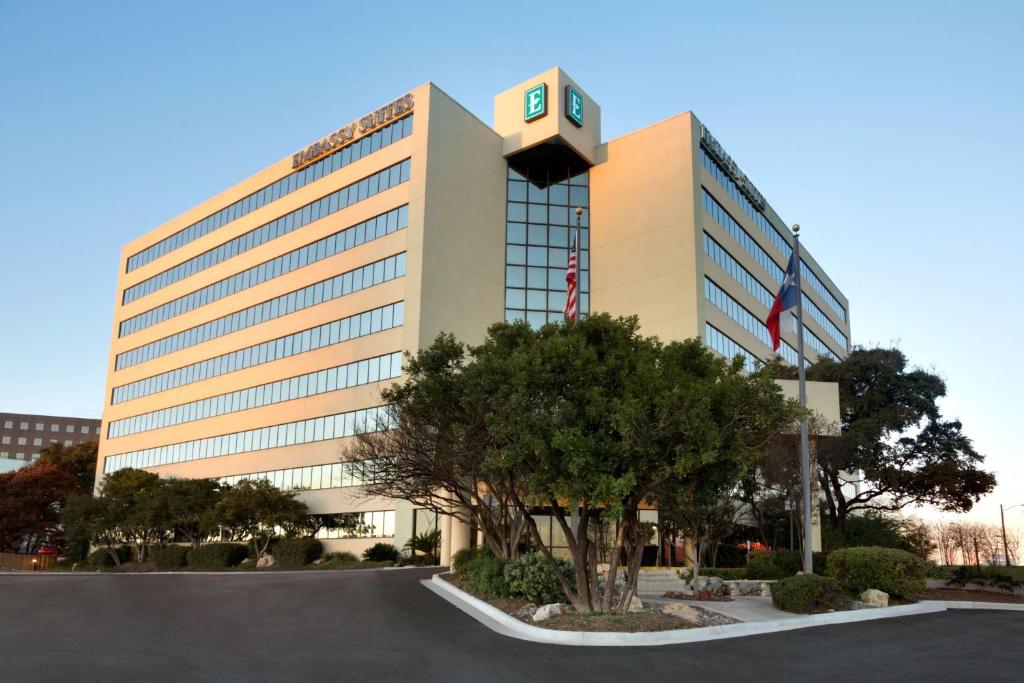 a large building with a clock on top of it at Embassy Suites San Antonio Airport in San Antonio
