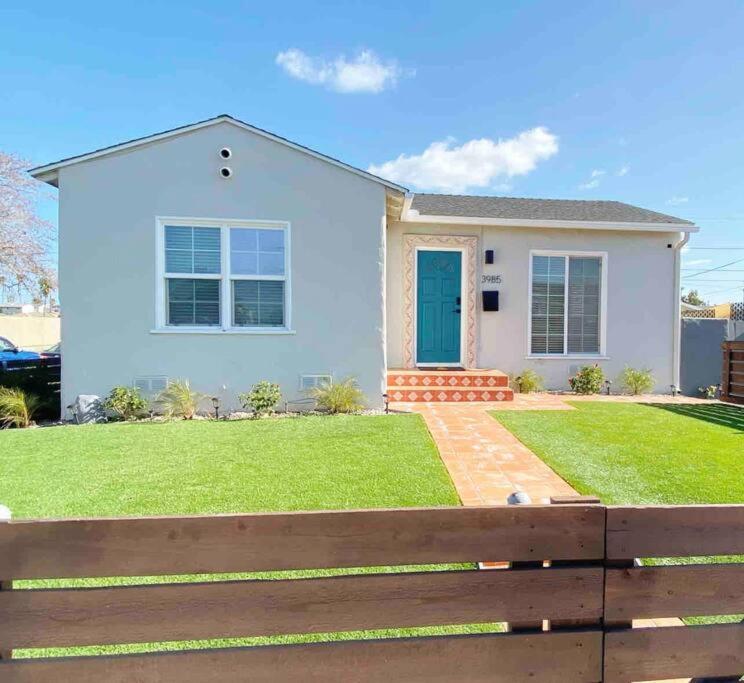 a white house with a fence in front of it at Crown Point Home w/ Cowboy Pool 2 Blocks to Bay in San Diego