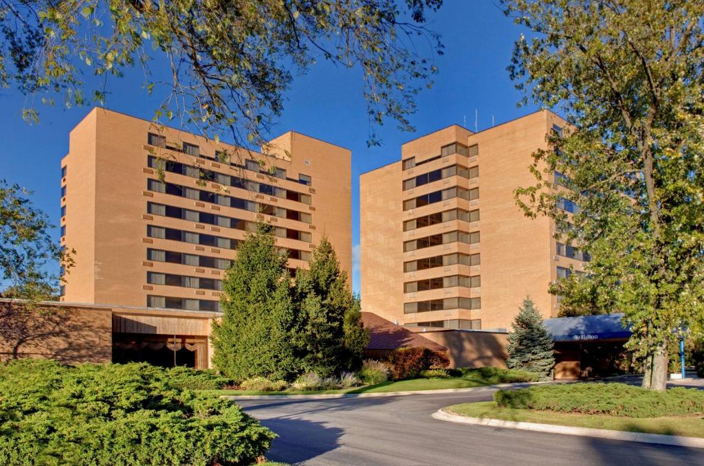 a road in front of two tall buildings at Hilton Chicago/Northbrook in Northbrook