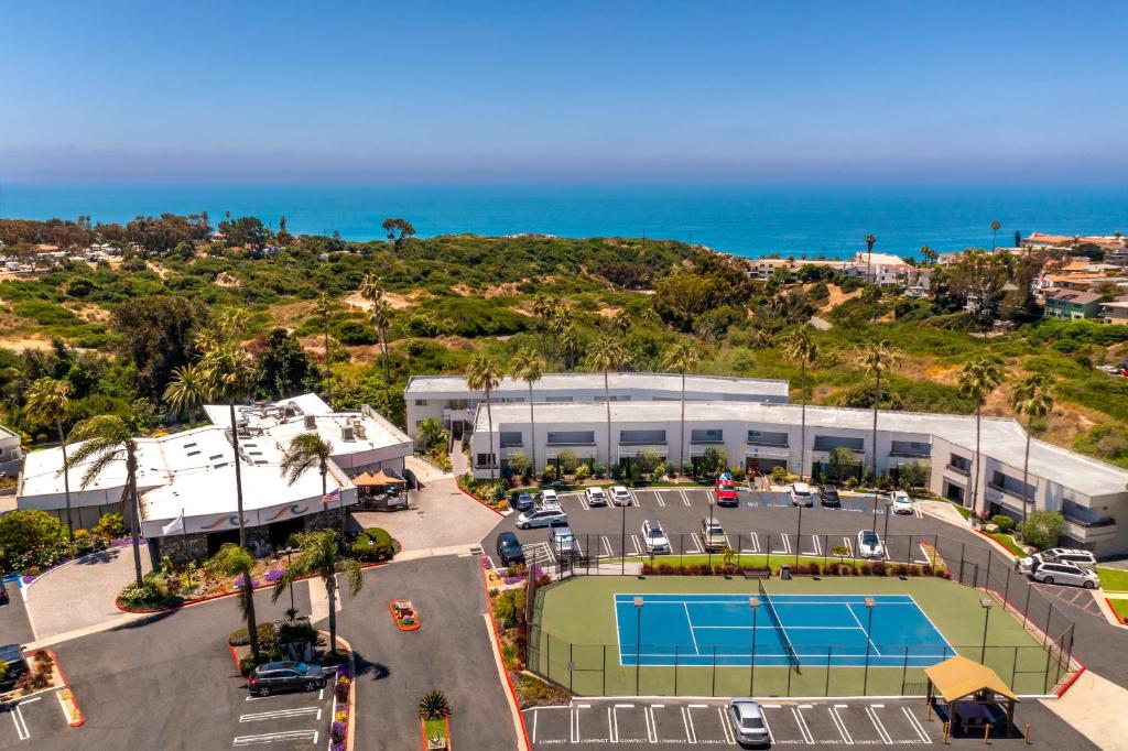 an aerial view of a tennis court and the ocean at San Clemente Inn in San Clemente