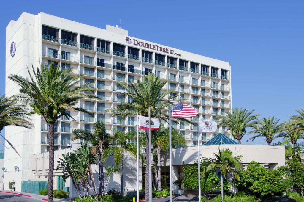 a hotel with palm trees in front of it at DoubleTree by Hilton Torrance - South Bay in Torrance