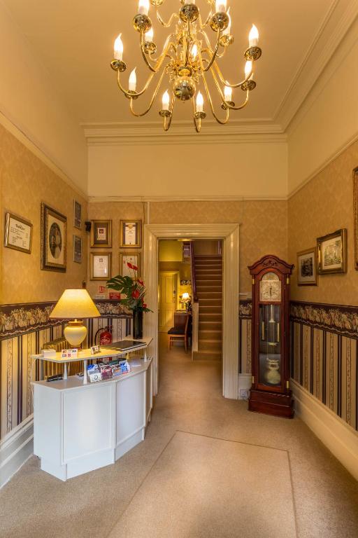 a large hallway with a chandelier and a room at Balincourt in Bournemouth