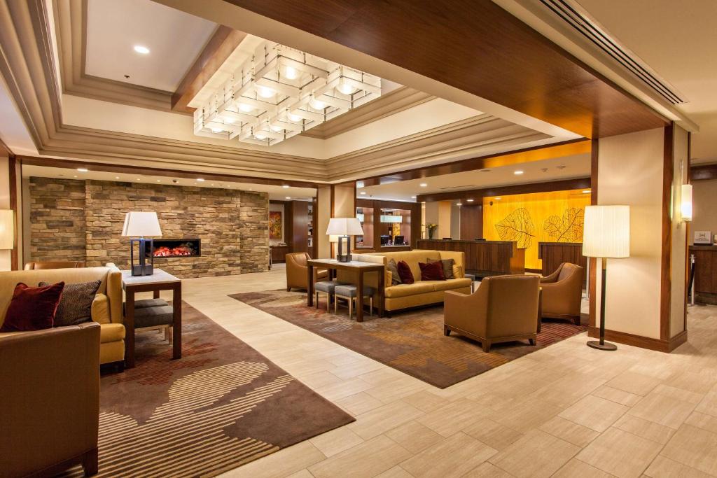 a lobby with couches and chairs and a fireplace at DoubleTree by Hilton Pittsburgh-Green Tree in Pittsburgh