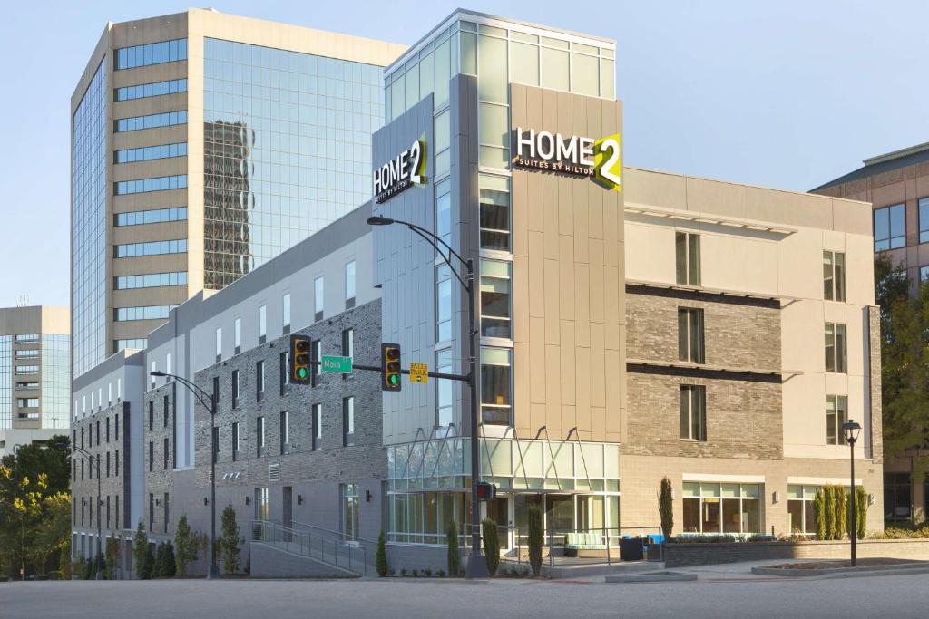 a large building with a home improvements sign on it at Home2 Suites by Hilton Greenville Downtown in Greenville
