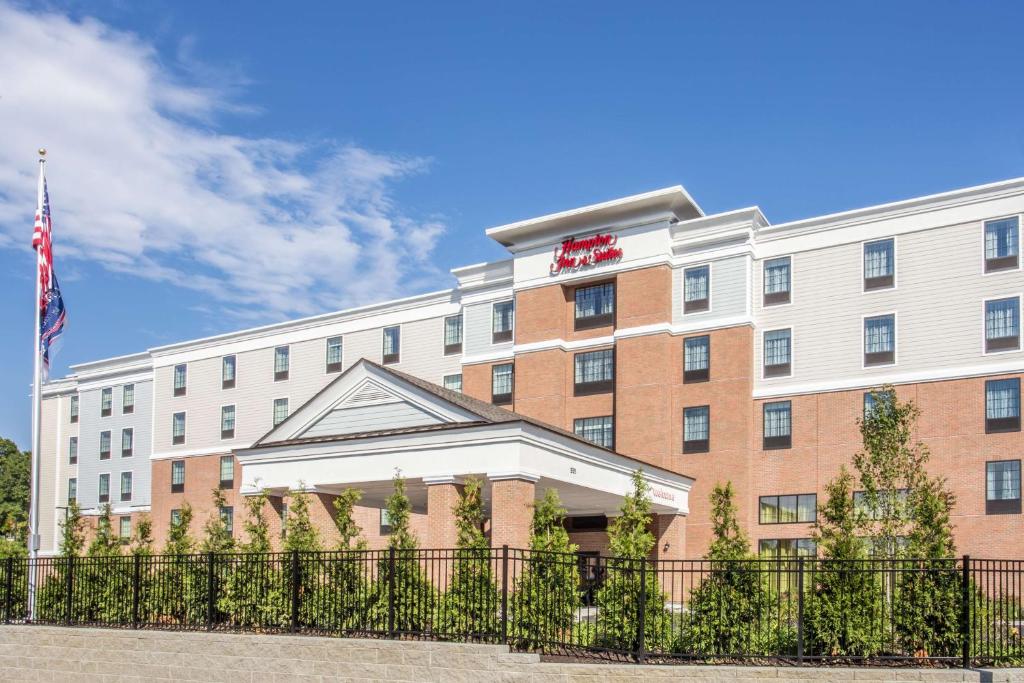 a hotel building with a fence in front of it at Hampton Inn & Suites Yonkers - Westchester in Yonkers