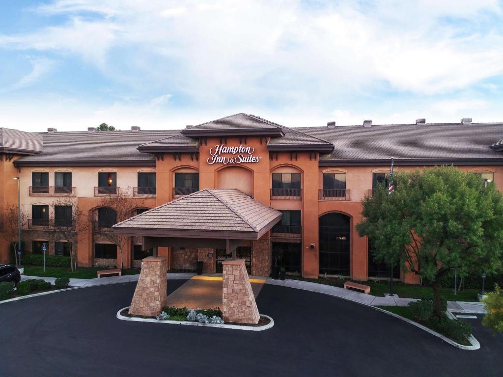 a building with a sign on the front of it at Hampton Inn & Suites Temecula in Temecula