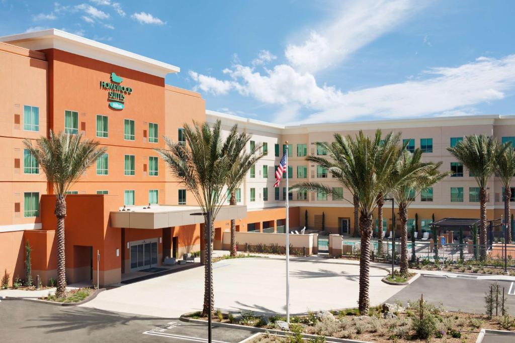 an image of the front of a hotel with palm trees at Homewood Suites By Hilton Irvine John Wayne Airport in Irvine