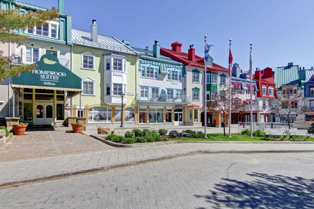 a street in a town with colorful buildings at Homewood Suites by Hilton Mont-Tremblant Resort in Mont-Tremblant