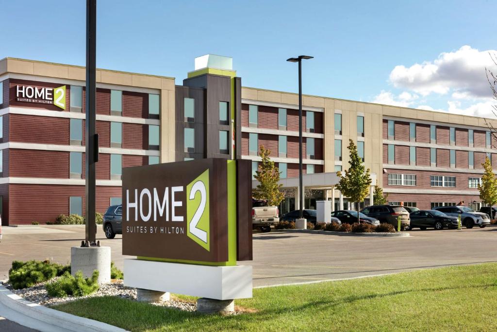 a home sign in front of a building at Home2 Suites by Hilton Fort St. John in Fort Saint John