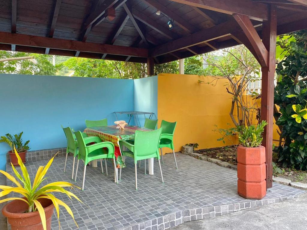a patio with a table and chairs on a patio at La Belle Escapade in Quartier du Fond Fleuri