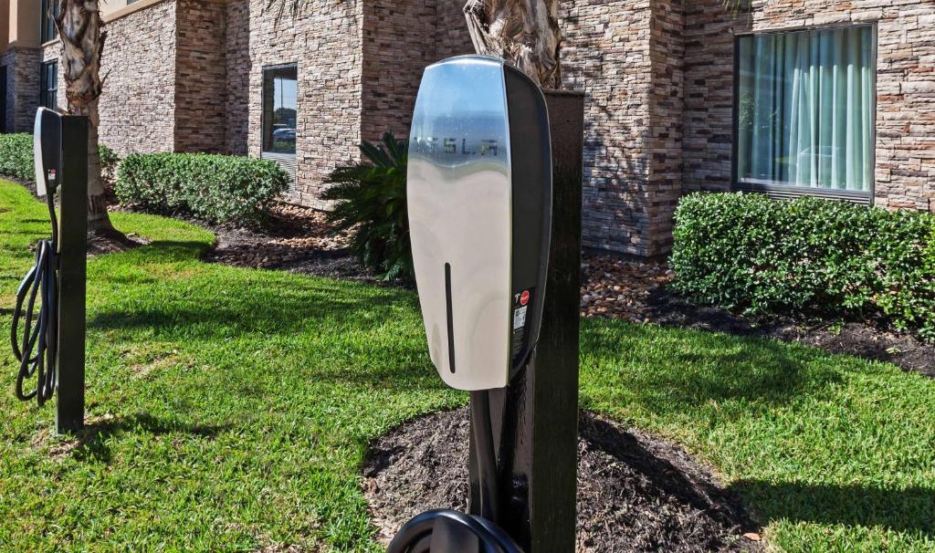 a mailbox in the grass in front of a building at Hampton Inn and Suites Lake Jackson-Clute in Clute