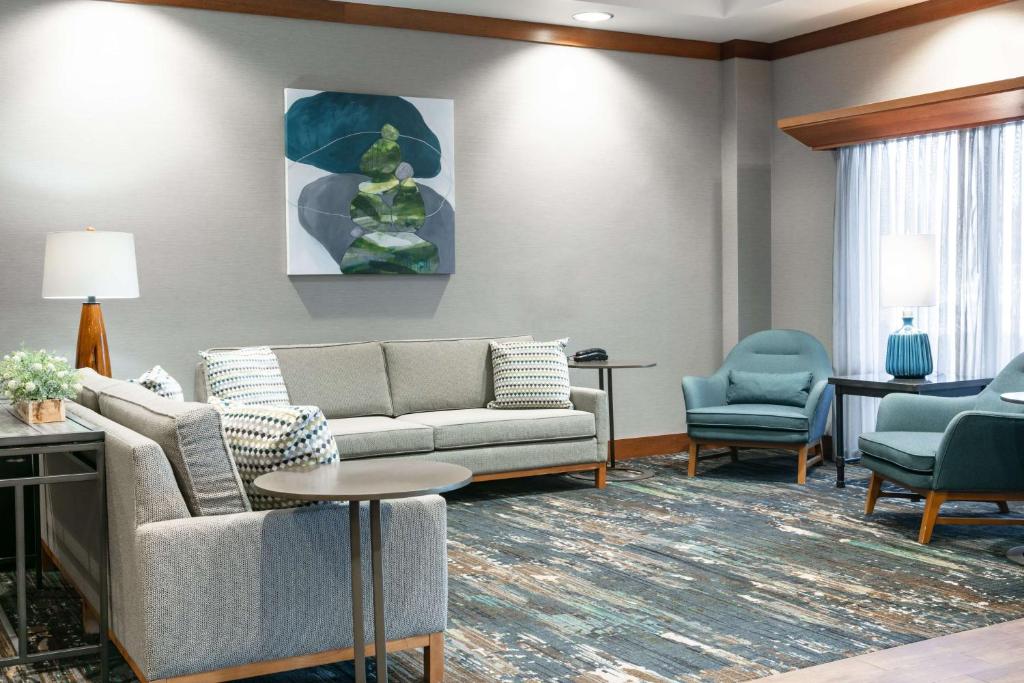 a living room with a couch and chairs and a table at Hampton Inn Council Bluffs in Council Bluffs