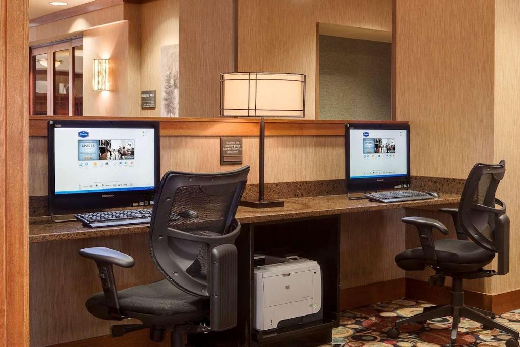 an office with two computer monitors and two chairs at Hampton Inn Council Bluffs in Council Bluffs
