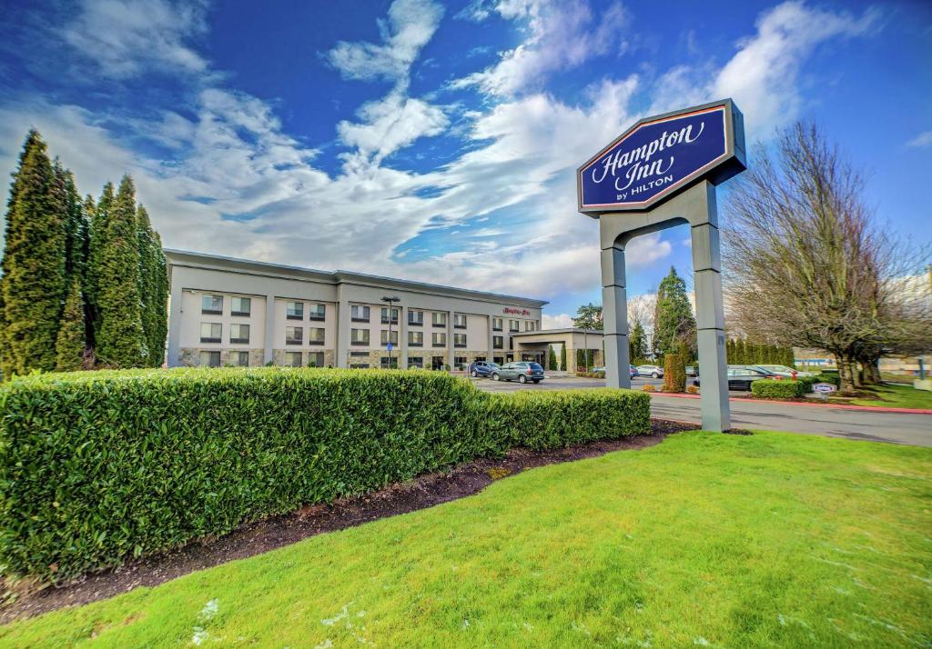 a sign for a hotel in front of a building at Hampton Inn Portland East in Portland