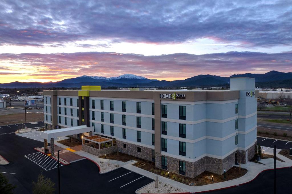 a hotel building with a view of the mountains at Home2 Suites By Hilton Redding in Redding