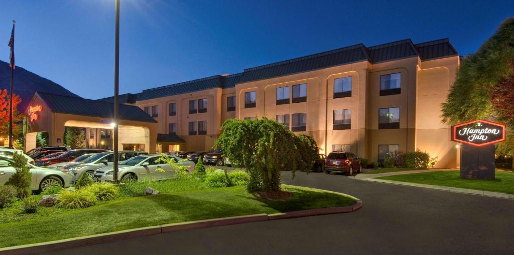 a hotel with a sign in front of a parking lot at Hampton Inn Provo in Provo