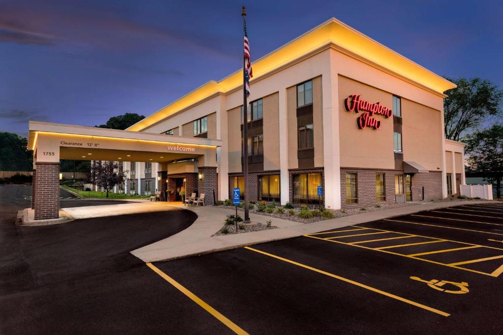 an empty parking lot in front of a hotel at Hampton Inn Rochester in Rochester