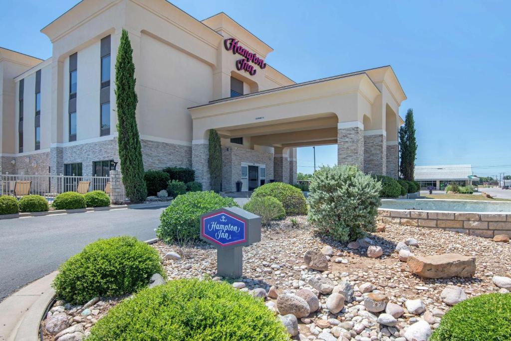 a hotel building with a sign in front of it at Hampton Inn Brownwood in Brownwood