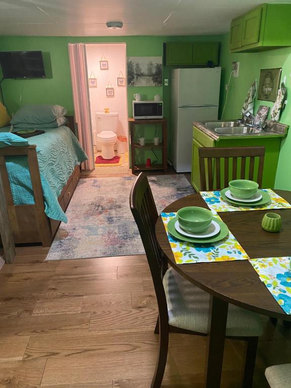 a small kitchen and dining room with a table at Angelas Village 